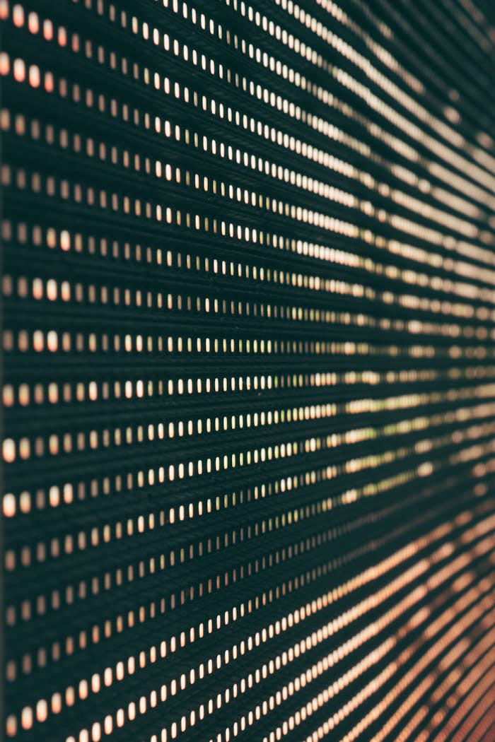 Abstract image featuring a close-up of an LED panel with glowing light patterns.